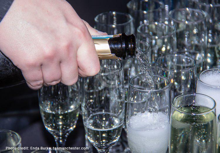 Champagne being poured into glasses at Concorde G-BOAC Jubilee Event